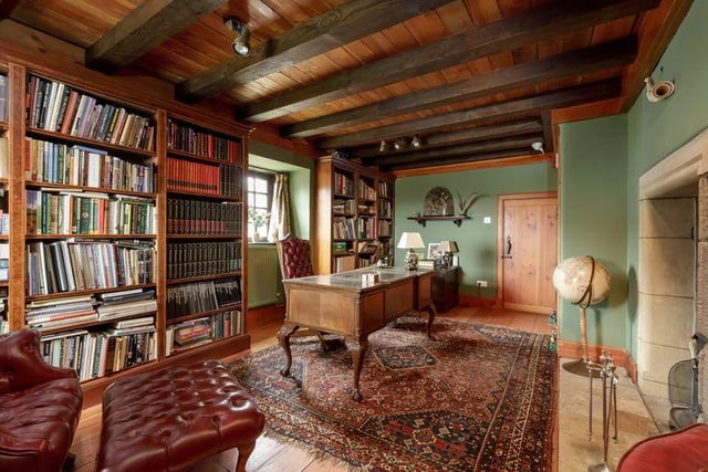 The study has an eye catching stone fireplace and plenty of space for a home library.