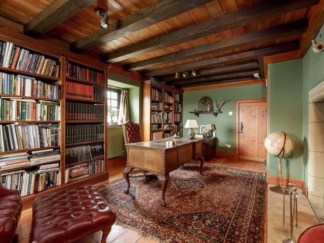 The study has an eye catching stone fireplace and plenty of space for a home library.