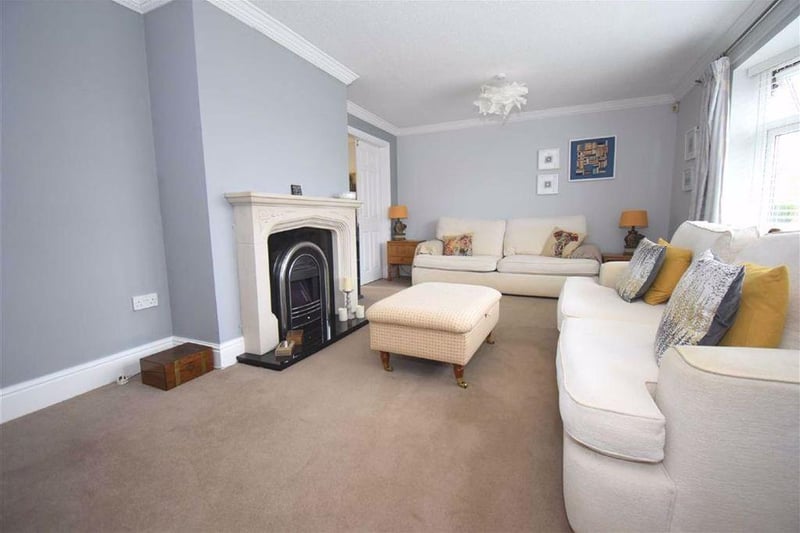 The living room has plenty of space and is fitted with an electric fire.