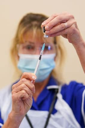 A member of the medical team draws up the Pfizer-BioNTech COVID-19 Vaccine at the Excelsior Academy on September 22, 2021 in Newcastle upon Tyne, England.