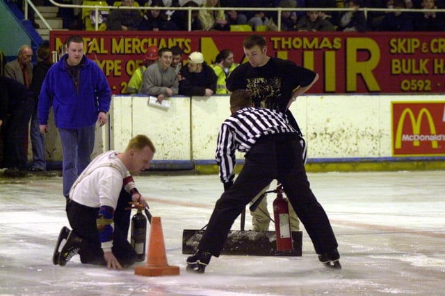 The match referee, rink staff and volunteers try to repair the damage to the ice  (Pic: Bill Dickman)