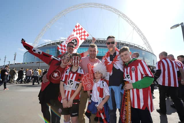 Sheffield United fans pose for a photo outside Wembley, before the FA Cup semi final against Hull City: Martin Rickett/PA Wire.
