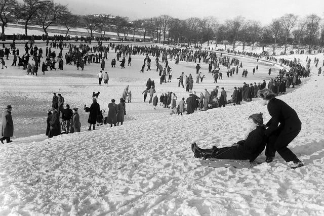 Hundreds of people take advantage of the winter weather to enjoy the snow in Inverleith Park in January 1955.