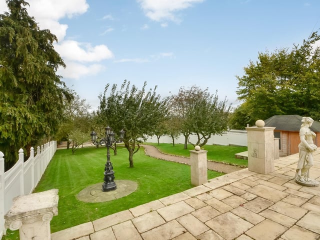 This huge five-bedroom Portsdown Hill home in Portsmouth is up for raffle. Pictured is its garden and the path to its indoor pool and annex.