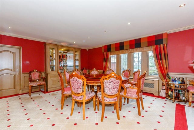 Vibrant in colour, the dining room provides a cosy space to enjoy meals with the family and boasts an internal picture window which overlooks the swimming pool.