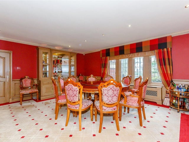 Vibrant in colour, the dining room provides a cosy space to enjoy meals with the family and boasts an internal picture window which overlooks the swimming pool.