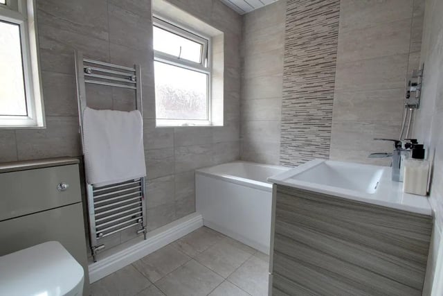 The bathroom has a lovely finish. It's light coloured tiling and furniture will keep the room bright by reflecting the light from the windows.
