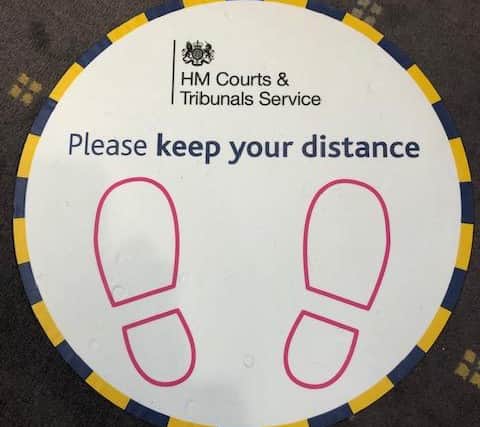 Pictured is one of the many Covid-19 social-distancing warning signs at Sheffield Crown Court.