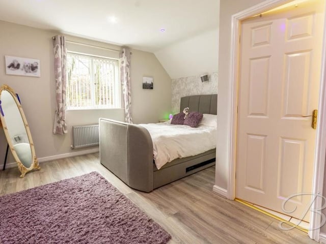 We're upstairs now and the landing leads to the master bedroom, which has laminate flooring, a central-heating radiator and a window to the side of the house.
