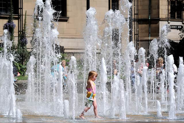 A youngster cools off in the fountain in Sheffield's Peace Gardens during warm weather. Sheffield has a sunny Saturday forcast today and  dry Platinum Jubilee bank holiday weather forecast also