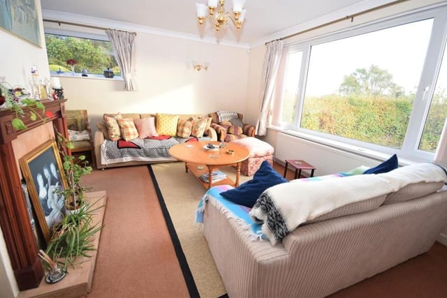 The rich warmth of the bungalow is underlined by this homely lounge. A large uPVC picture window offers far-reaching views, while a second window at the side enhances the room's natural light.