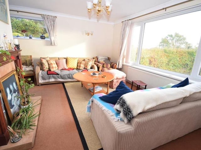 The rich warmth of the bungalow is underlined by this homely lounge. A large uPVC picture window offers far-reaching views, while a second window at the side enhances the room's natural light.