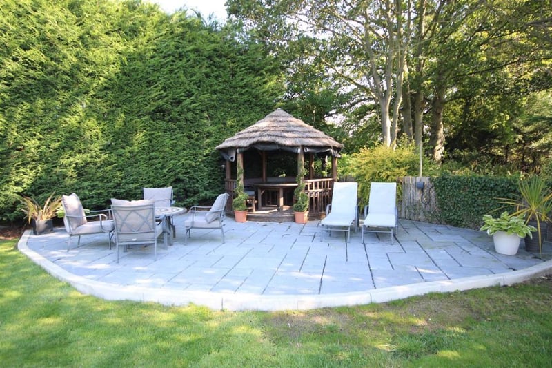 The extensive gardens boast spacious seating areas and mature trees.