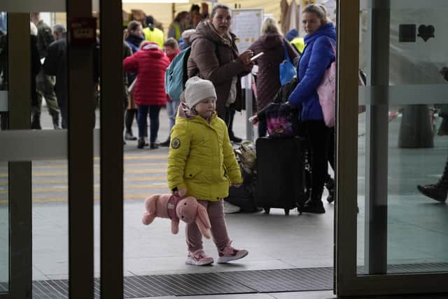 Ukrainian refugees wait at central train station in Warsaw, Poland, on Wednesday, March 30, 2022. The U.N. refugee agency says more than 4 million people have now fled Ukraine following Russia's invasion, a new milestone in the largest refugee crisis in Europe since World War II. (AP Photo/Czarek Sokolowski)
