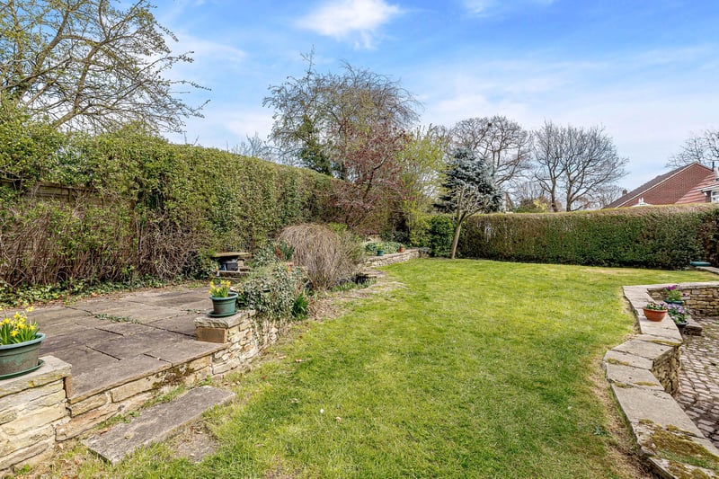 In the back garden is a privately enclosed lawned area, two patio areas, hedge boundaries, an ornamental pond and flower borders.