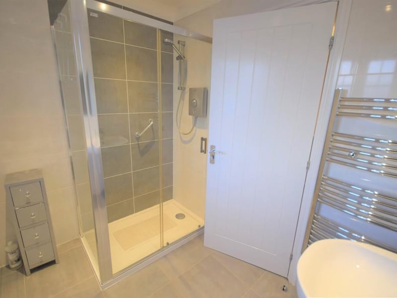 A good sized contemporary suite with matching wall and floor tiles, corner shower cubicle and Aqualisa shower, wc, wash hand basin, shaver point, chrome towel rail, downlights to the ceiling and double glazed obscure window.