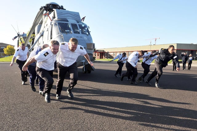 2013. Sailors from HMS Sultan pull a helicopter for Children in Need
Pictured - Staff from The Royal Navy Air Engineering and Sea Survival  School during their run.



Today, 15th November 2013, an Aircraft Pull took place on the Parade Ground of HMS Sultan to raise money for the Children in Need Appeal.



Sea King helicopters were set up, and teams of 10 pulled the aircraft in the fastest possible time.