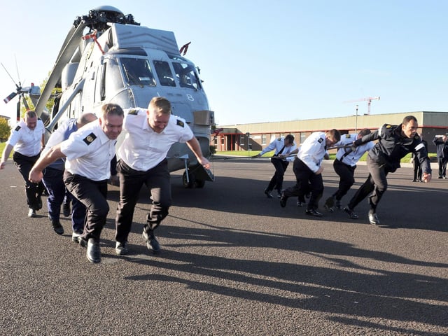 2013. Sailors from HMS Sultan pull a helicopter for Children in Need
Pictured - Staff from The Royal Navy Air Engineering and Sea Survival School during their run.
Today, 15th November 2013, an Aircraft Pull took place on the Parade Ground of HMS Sultan to raise money for the Children in Need Appeal.
Sea King helicopters were set up, and teams of 10 pulled the aircraft in the fastest possible time.