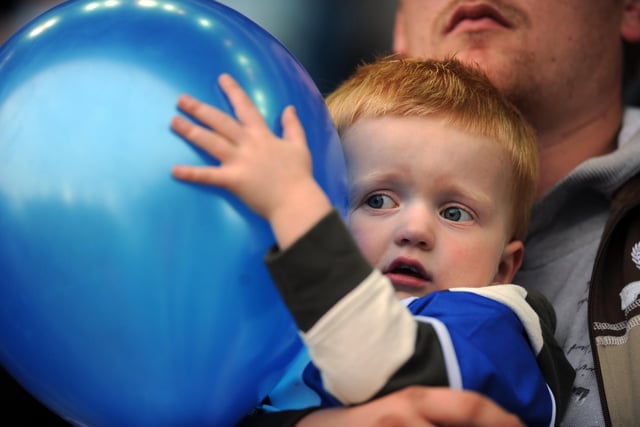 One young fan dare not watch as he hides behind his balloon against Norwich City at Hillsborough in May 2008.