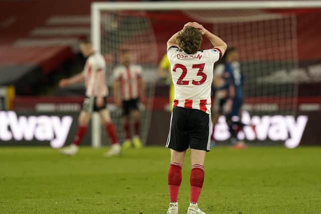 Ben Osborn looks dejected as Arsenal score their second of three goals against Sheffield United: Andrew Yates / Sportimage