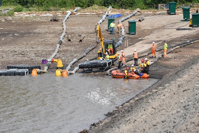 Work continued to drain and shore up the damaged dam on August 5, 2019