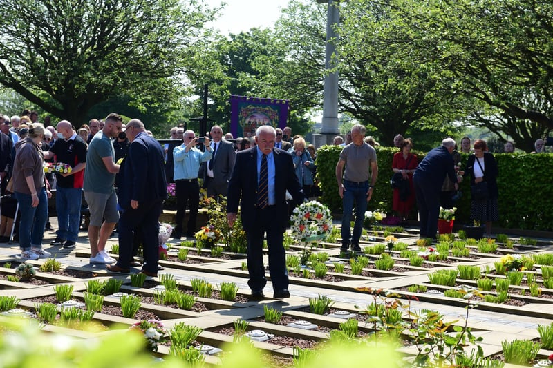 People gather at the graves of those killed in the disaster.