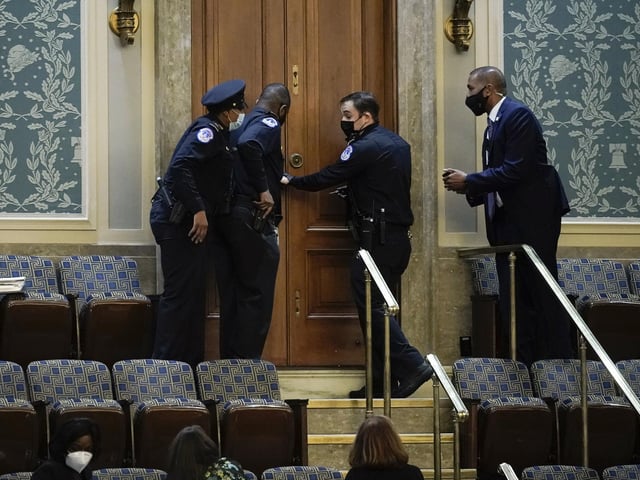 U.S. Capitol Police secure a door as protesters try to break into the House Chamber at the U.S. Capitol on Wednesday, Jan. 6, 2021, in Washington. (AP Photo/J. Scott Applewhite)
