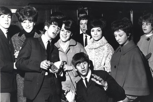 Paul McCartney, George Harrison and Ringo Starr and fans at the Beatles City hall concert on November 2 1963