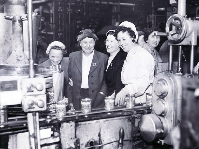 Batchelors Foods Sheffield in February 1958. This picture shows Ellen Foy (in white overall), who is in the canning department, during a visit.