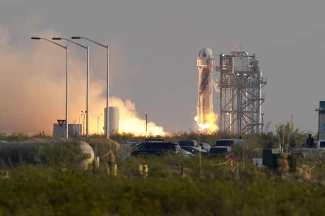 Blue Origin's New Shepard rocket launches carrying passengers Jeff Bezos, founder of Amazon and space tourism company Blue Origin, brother Mark Bezos, Oliver Daemen and Wally Funk, from its spaceport near Van Horn, Texas, Tuesday, July 20, 2021. (AP Photo/Tony Gutierrez)