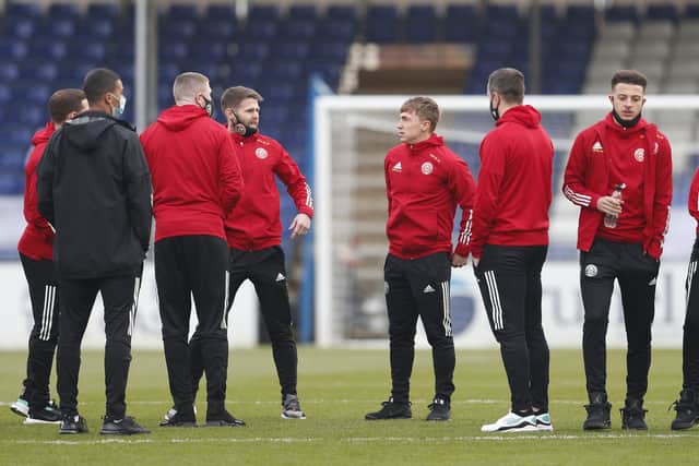 Ben Osborn speaks to Oliver Norwood (fourth from left) before Sheffield United's win over Bristol Rovers: Darren Staples/Sportimage