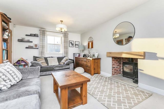 The luxurious lounge is a good size and includes a feature fireplace with log burner inside. The floor is carpeted, while double-glazed windows face the front and rear of the property.