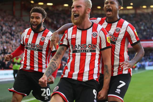 Oliver McBurnie (centre) says Sheffield United's stars are buzzing to see Jayden Bogle (left) return from injury: Simon Bellis / Sportimage