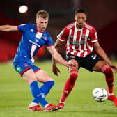 Sheffield United's Daniel Jebbison (right) and Carlisle United's George Tanner battle for the ball: Zac Goodwin/PA Wire
