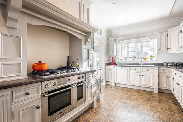 The fitted kitchen and breakfast room has elegant Corian work surfaces and Amtico flooring.