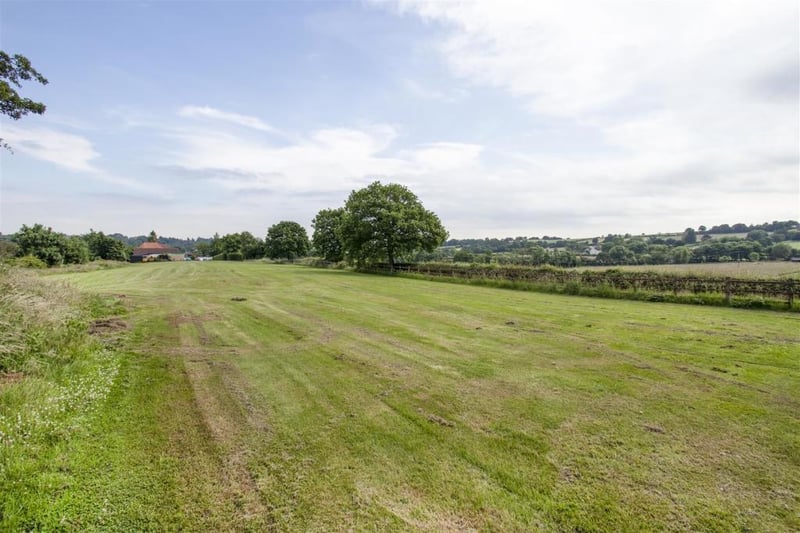 The property boasts a large open paddock with woodland.