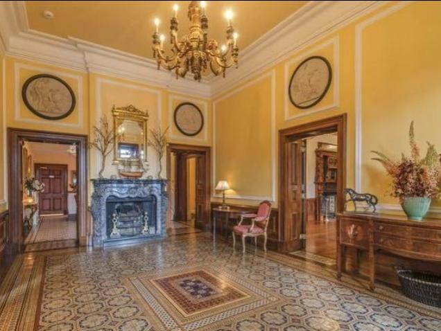 Leading through a secret panelled door is the sitting room with a large limestone open fireplace, delicate ceiling decoration and a bespokely made bookshelf. This room overlooks the side lawn and terrace beyond. The inner hall leads to a study, cloakroom, butlers pantry and into the magnificent open plan kitchen/breakfast room.