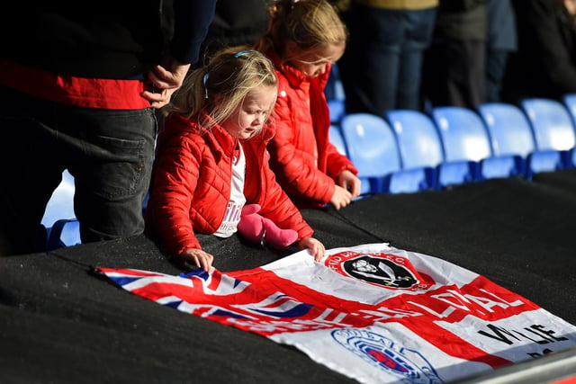 A young United fan places a flag pitch-side before the 1-0 win over Crystal Palace at Selhurst Park in February 2020.