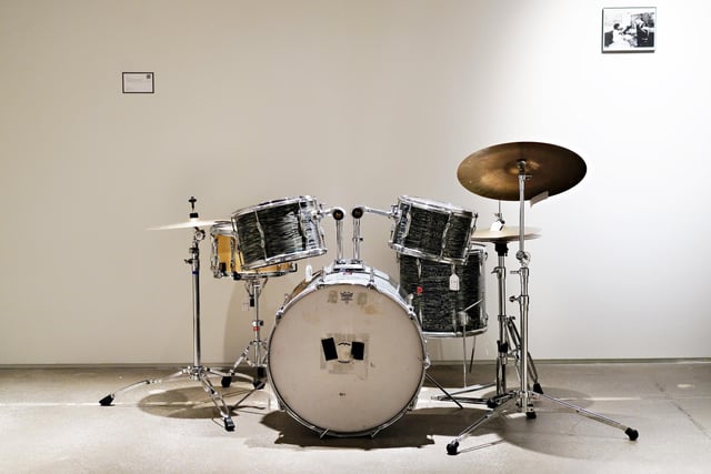 Which band's drummer designed a custom electronic drum kit after he lost his left arm in a car crash? (Photo by Cindy Ord/Getty Images)