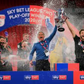 Northampton Town Manager Keith Curle lifts the trophy with captain Charlie Goode following the Sky Bet League 2 Play-Off Final match with Exeter City at Wembley Stadium, London on Monday 29th June 2020.