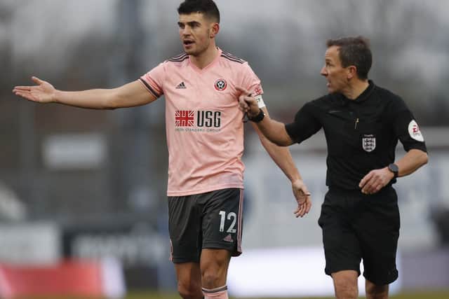 John Egan of Sheffield United speaks to referee Keith Stroud during the FA Cup match at the Memorial Stadium, Bristol: Darren Staples/Sportimage