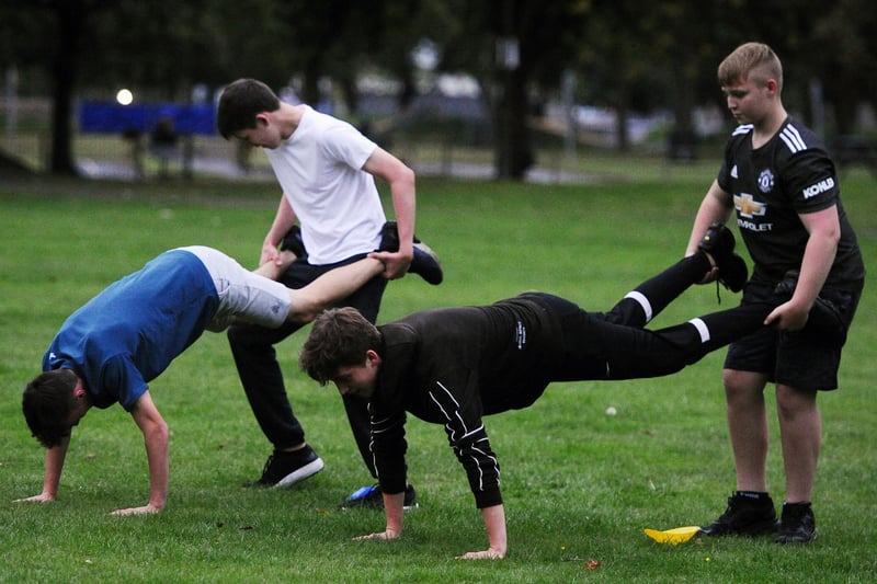 Youngsters get in some wheelbarrow action during their park-based fitness session