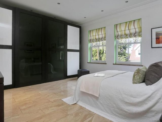 The bright and airy fourth bedroom boasts a fitted wardrobe that emits a scented vapour to keep your clothes smelling fresh. It has internal lighting, shelves, a pull-down hanging space and drawer units.