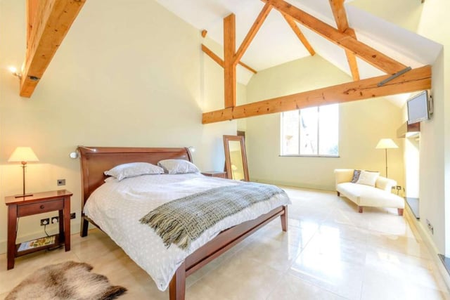 The large master suite is found on one wing of the property and boasts its own vaulted bedroom overlooking the woods behind the property as well as the courtyard. The property has four bedrooms in total.