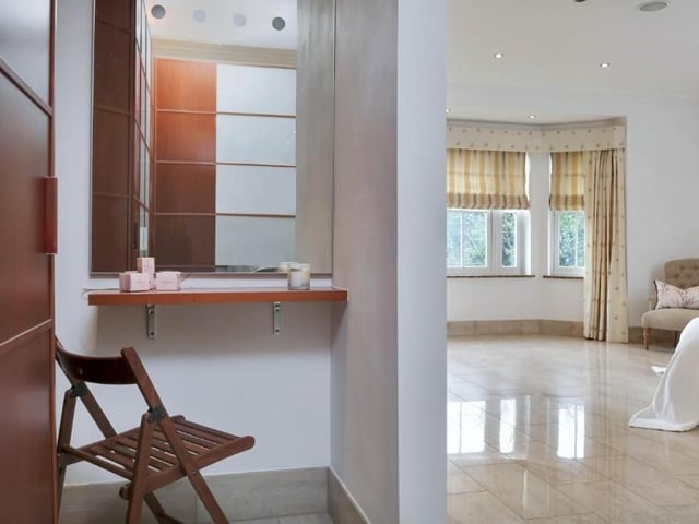 Another view of the master bedroom. It includes this vanity shelf, tucked away in a private enclave.
