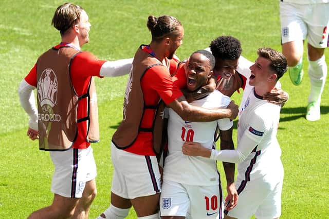 England's Raheem Sterling (centre) celebrates scoring at Wembley Stadium.