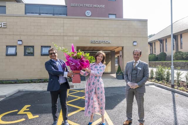 The Duchess of Northumberland is presented with flowers by Malhotra Group chairman Meenu Malhotra, (left) and Bunty Malhotra, managing director.