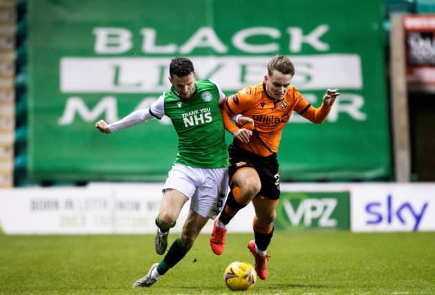 Paul McGinn battles for the ball with United goalscorer Luke Bolton