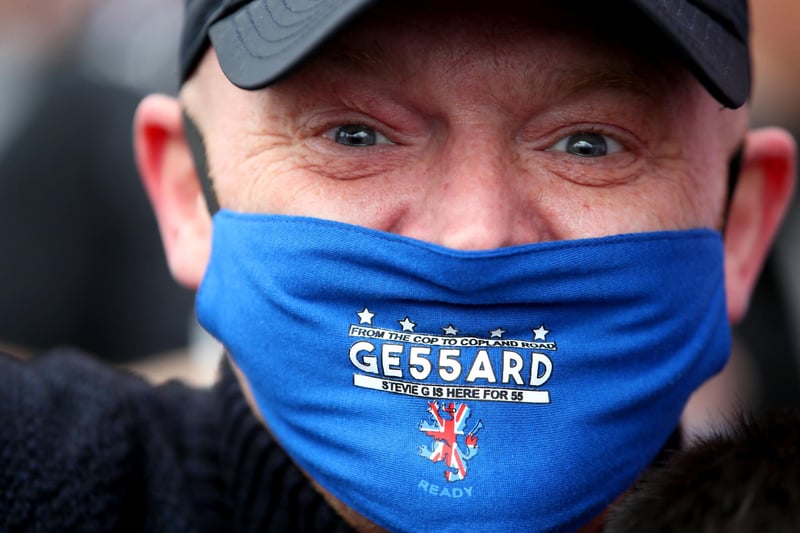 A Rangers fan wearing a celebratory face mask outside of the Ibrox Stadium after Rangers win the Scottish Premiership title.