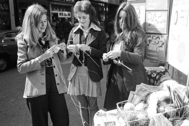 Three girls knitting at the Be a Knit for Oxfam campaign in Buchanan Street Glasgow, August 1974